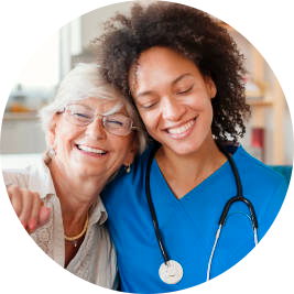 A female cancer doctor with her arm around an elderly female patient