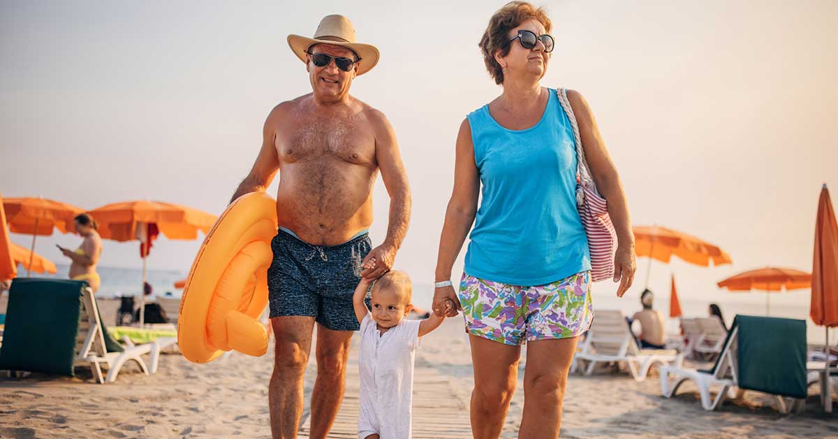 Grandparents at the beach with toddler