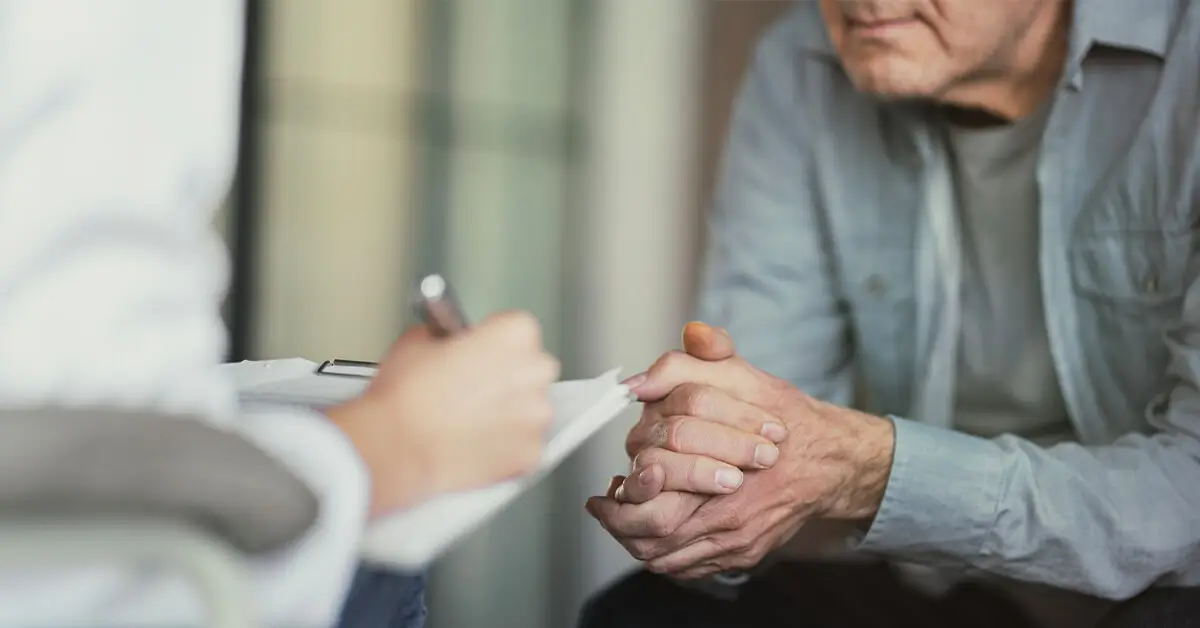 doctor speaking to older man