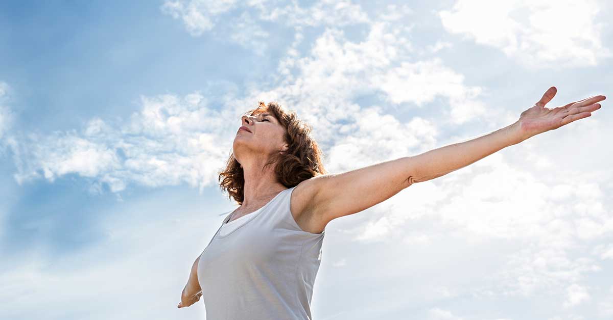 Zen middle aged yoga woman opening up her chakra