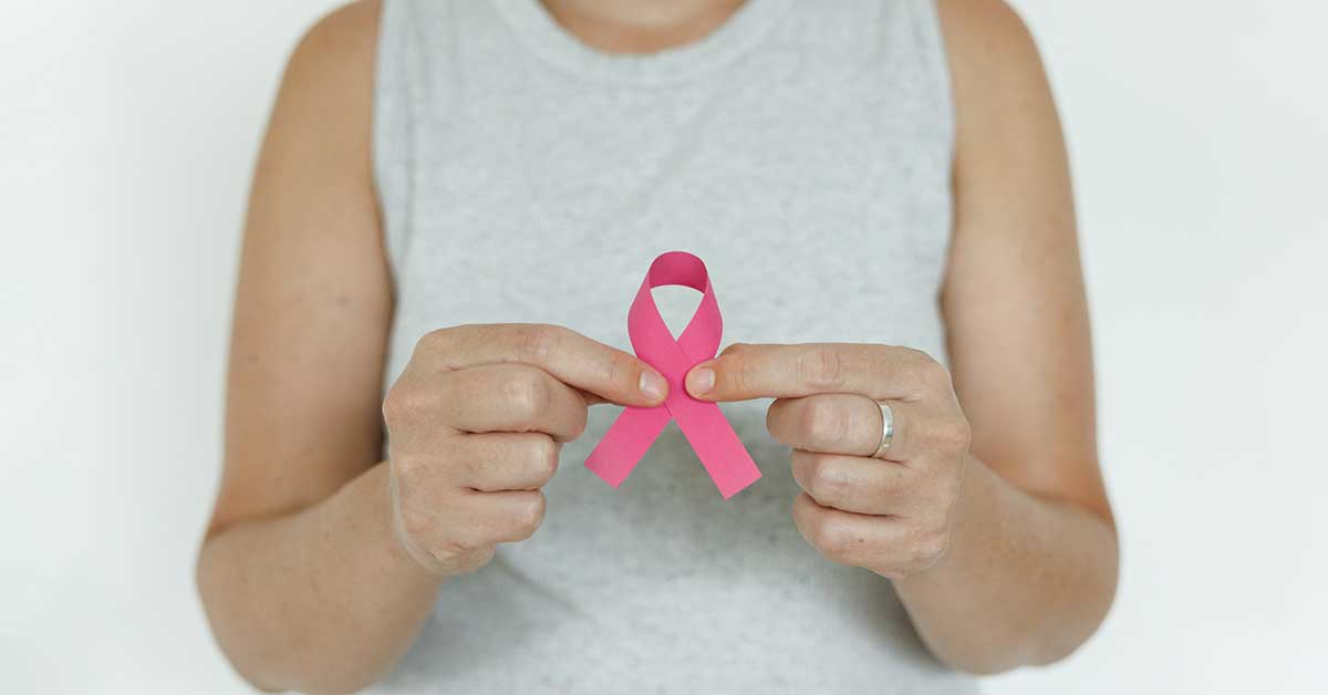 woman holding breast cancer ribbon