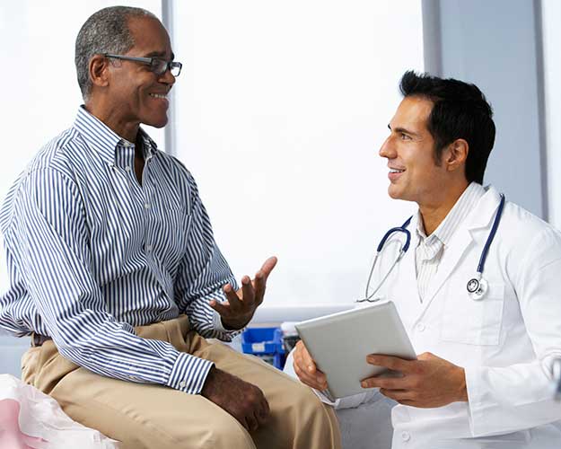 Mature man talking to Male doctor