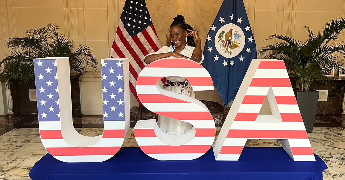 Woman in front of USA Letters