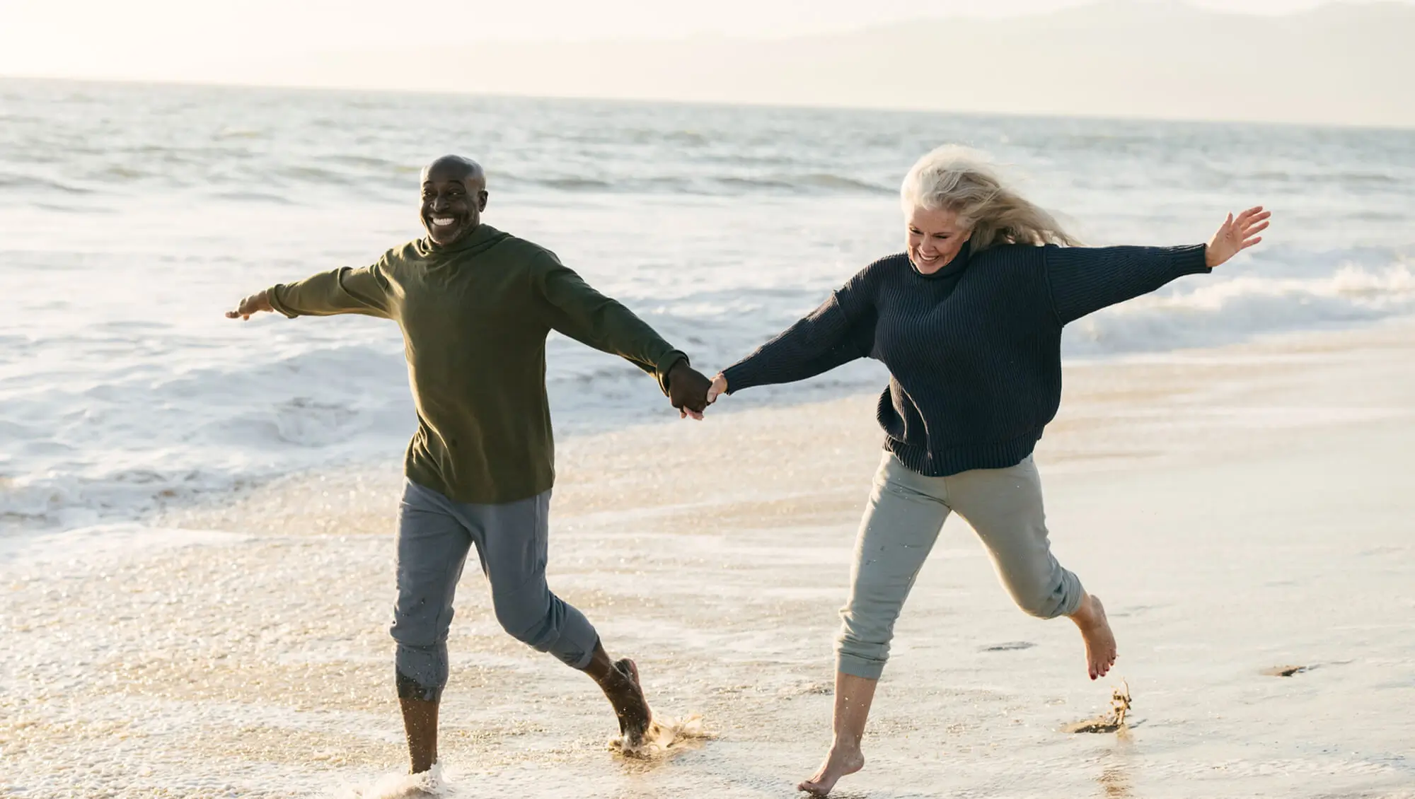 Man and Woman Playing On Beach